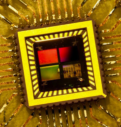 Photograph of an oxide chip containing several hundred thousand LaAlO3 - SrTiO3 field effect transistors. The colors are caused by light interfering with the transistor arrays (Carsten Woltmann).