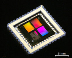 Fig. Chip:Photograph of a LaAlO3–SrTiO3 chip carrying arrays with more than 700.000 FETs with channel lengths as small as ~ 350 nm. The colors are interference colors arising from the transistor patterns.