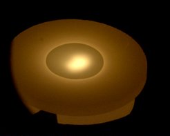 Fig.2:Freestanding Si source (12.7mm in diameter and 4mm thick) during deposition. A liquid phase can clearly be seen on the surface of the source.