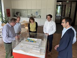 Prof Kern(first on the left) together with ministry delegation stand in front of the model of the precision lab.